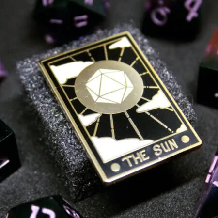 Enamel Pin enamel pin depiciting a tarot card of "The Sun" with a white D20 in the center of a golden circle